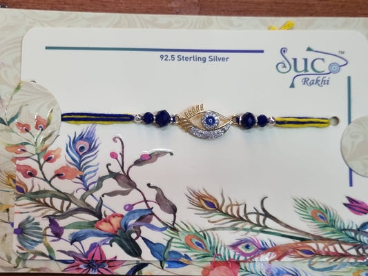 92.5 Sterling Silver rakhi on a decorative card with floral and peacock designs.